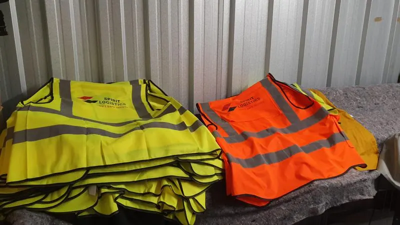 Custom printed hi-vis safety vests in yellow and orange with company logos